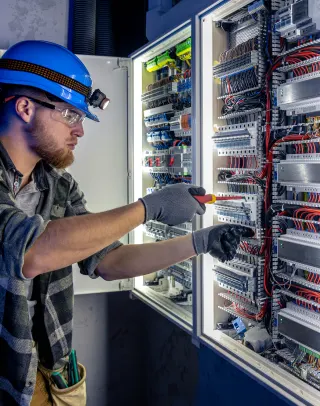 Hombre trabaja en un tablero eléctrico